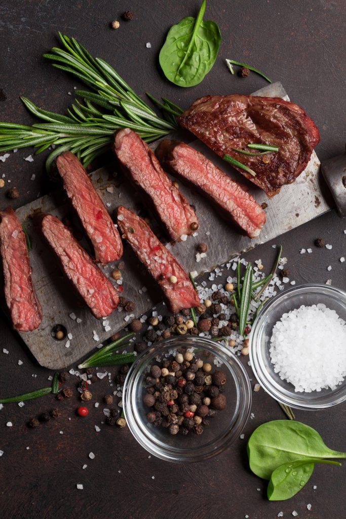 Top blade or denver grilled steak over meat butcher knife. Top view